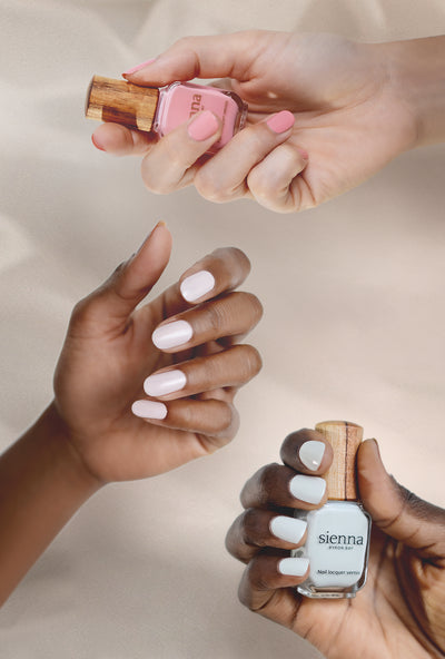 fair, medium and dark skin tone hands holding and wearing pastel nail polish colours by sienna byron bay