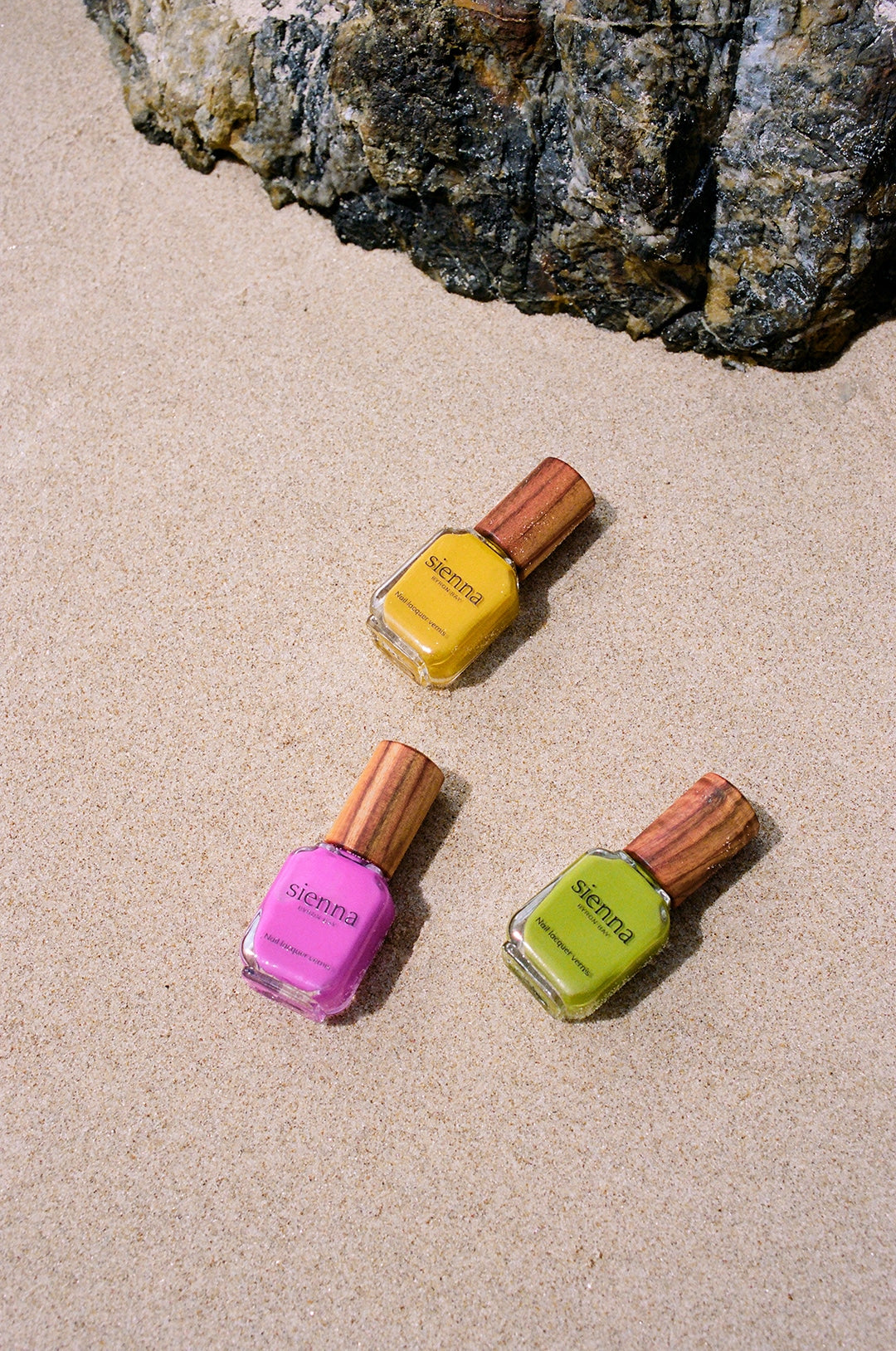 pink yellow and green nail polish bottles with timber cap by sienna
