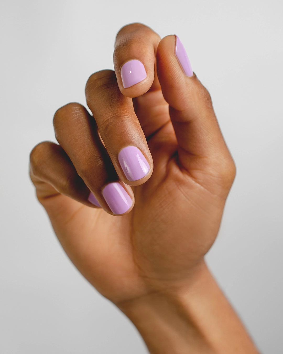 lilac nail polish hand swatch on medium skin tone by sienna