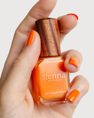 Bright papaya orange nail polish swatch on fair Skin tone by Sienna Byron Bay