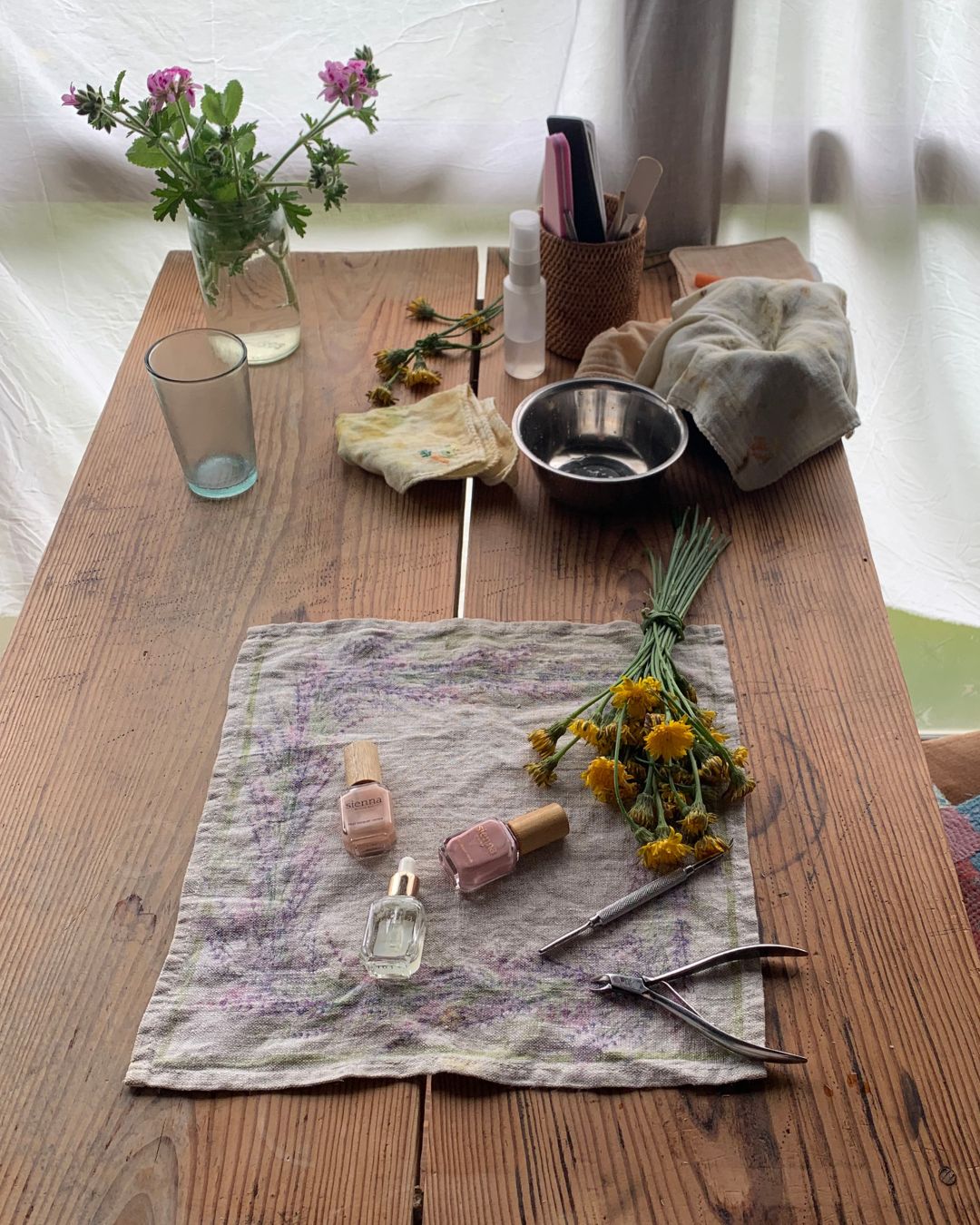 Wooden table set with beautiful natural nail care and hand picked flowers