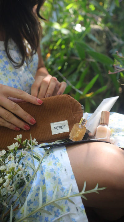 Woman seated in the garden unpacking the Ritual Kit