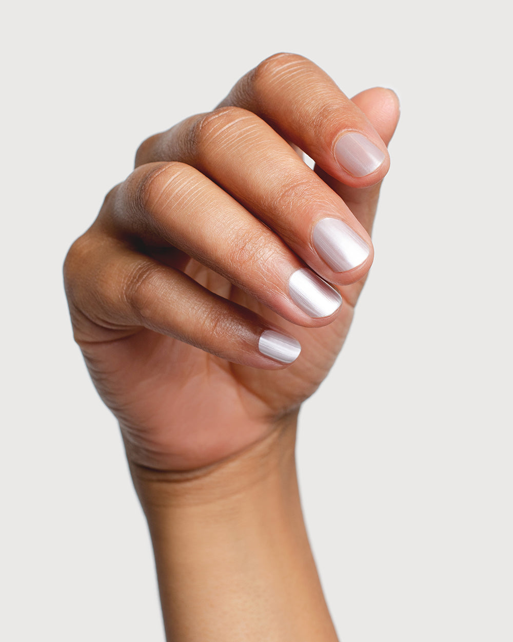 white pearl glazed nail polish hand swatch on medium skin tone