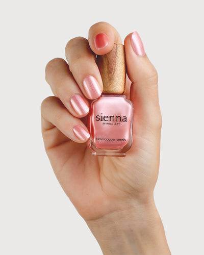 Warm Pink Satin Nail Polish on Fair Skin Tone with Glass Bottle 