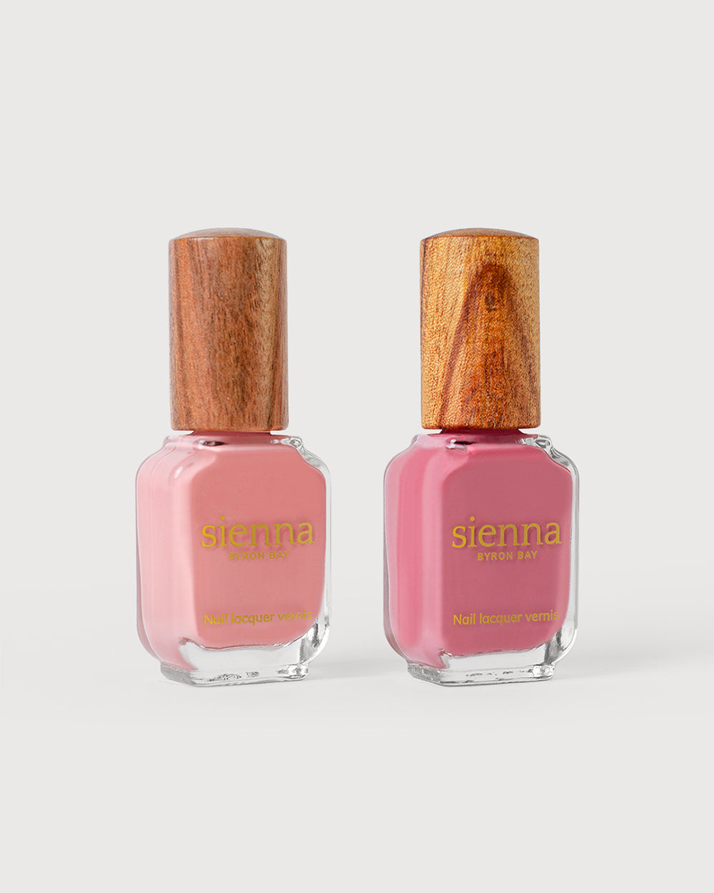 peachy pink and midtone pink nail polish glass bottles with timber cap