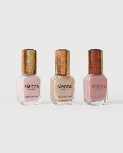 light rosewater pink sheer, Grapefruit Granita Crystal and Dusty rose nail polish bottles with timber caps