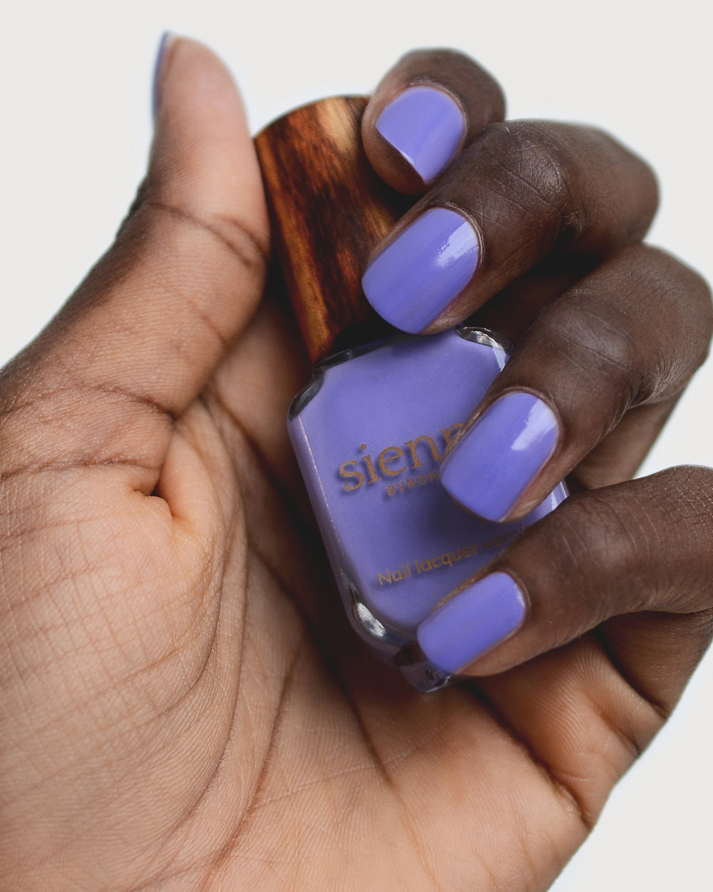 Gentle  Blue Lilac Crème nail polish by Sienna Byron Bay on dark skin tone hand.