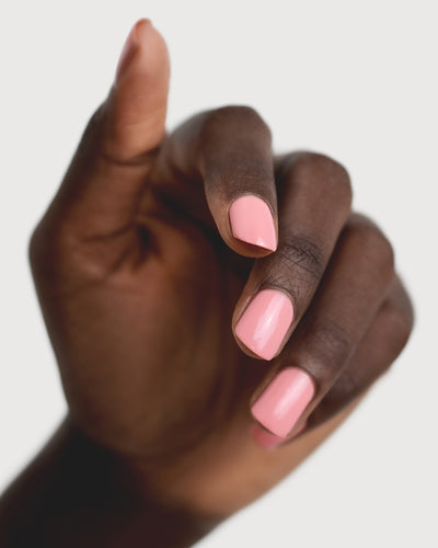 eachy pink nail polish hand swatch on dark skin tone