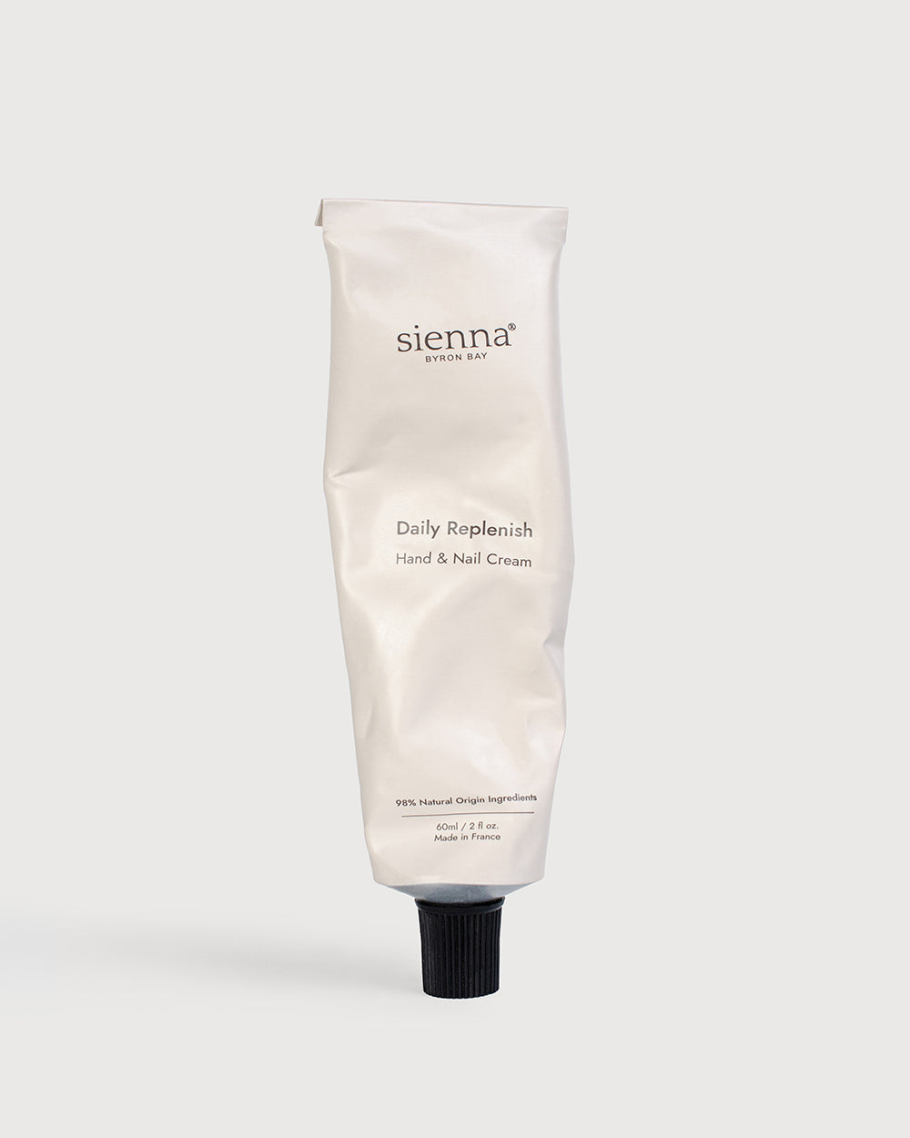Crumpled, well loved hand cream tube of Daily Replenish Hand and Nail Cream by Sienna Byron Bay.