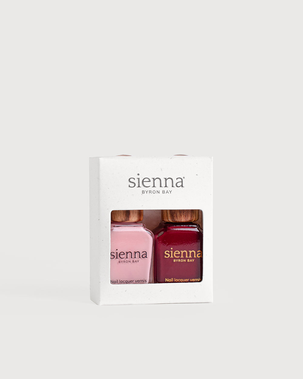 Cherry Blossom Crème and Plum red nail polish glass bottles with timber caps in a box