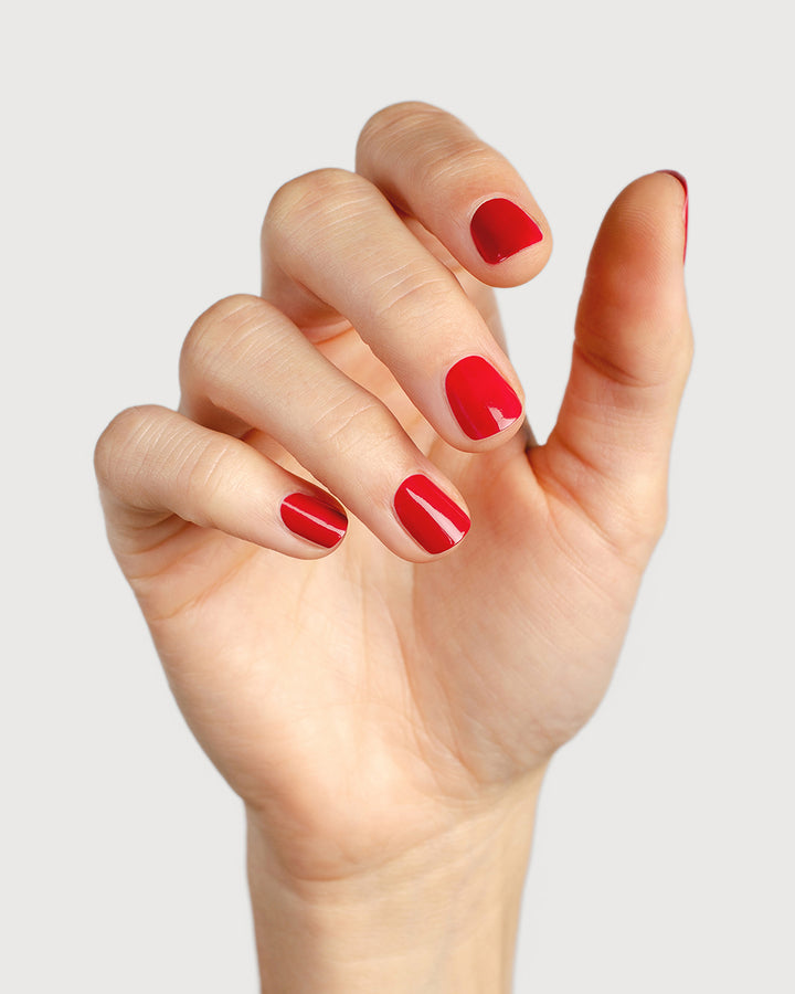 classic red nail polish hand swatch on fair skin tone 