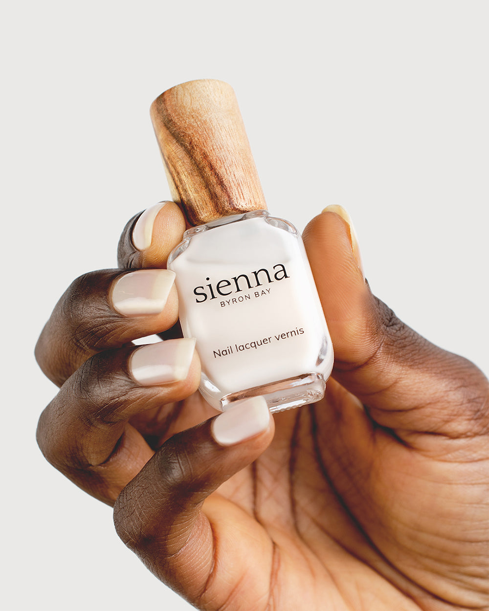 Milky Sheer White nail polish on dark skin tone with Sienna Bottle
