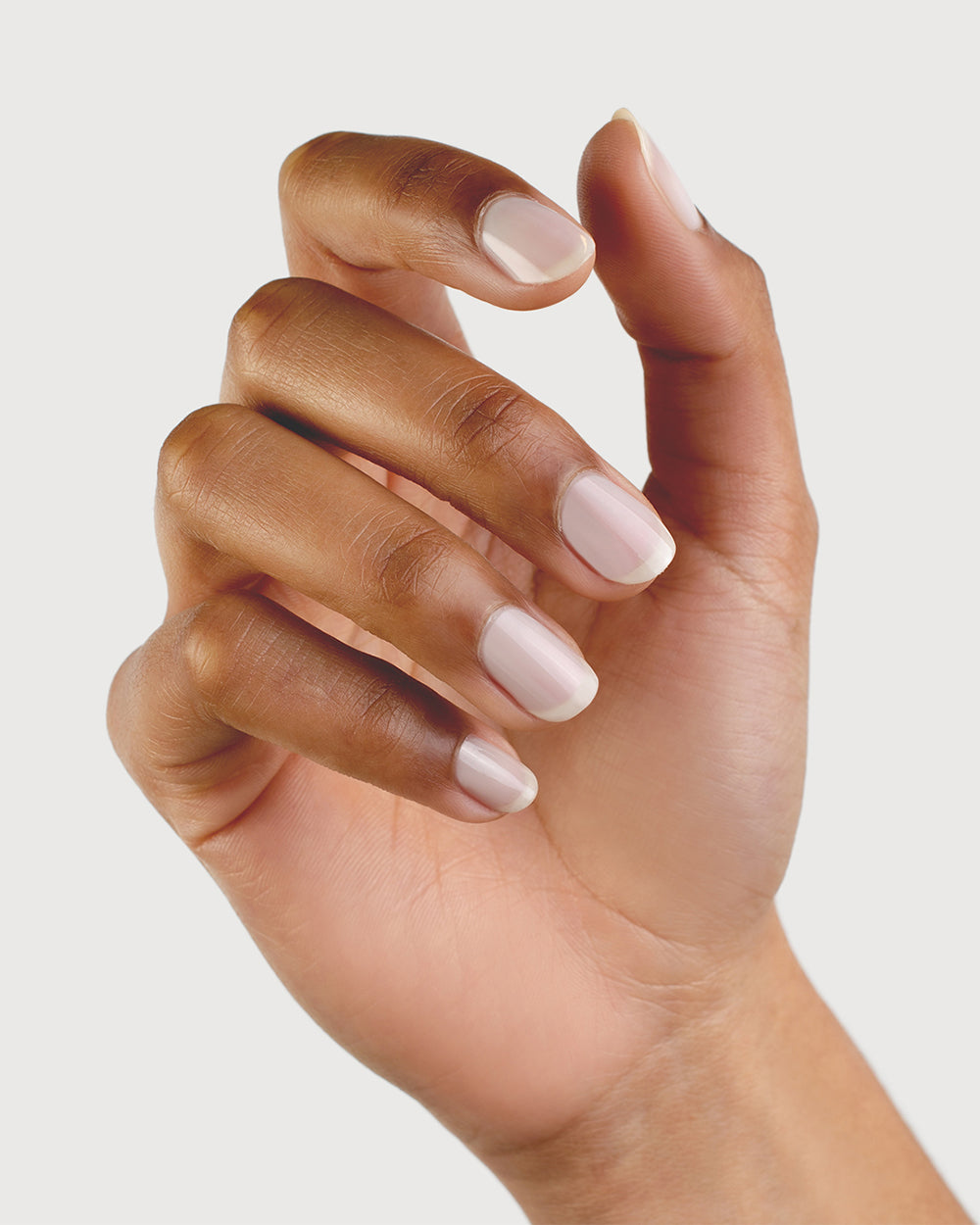 Milky Sheer White nail polish on medium skin tone