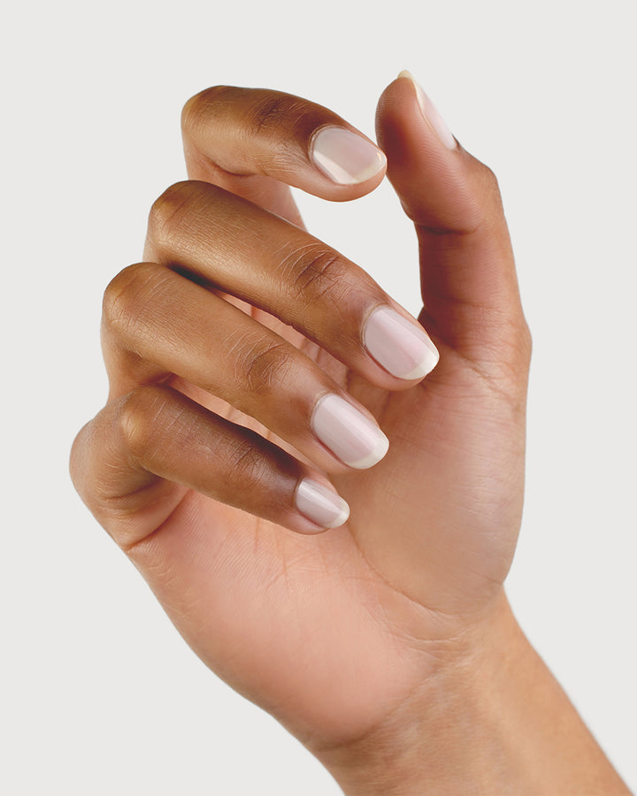 Milky Sheer White nail polish on medium skin tone