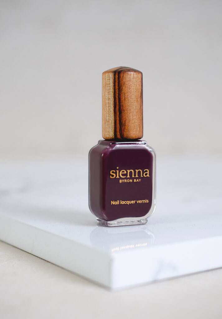dark aubergine nail polish bottle with timber cap by sienna