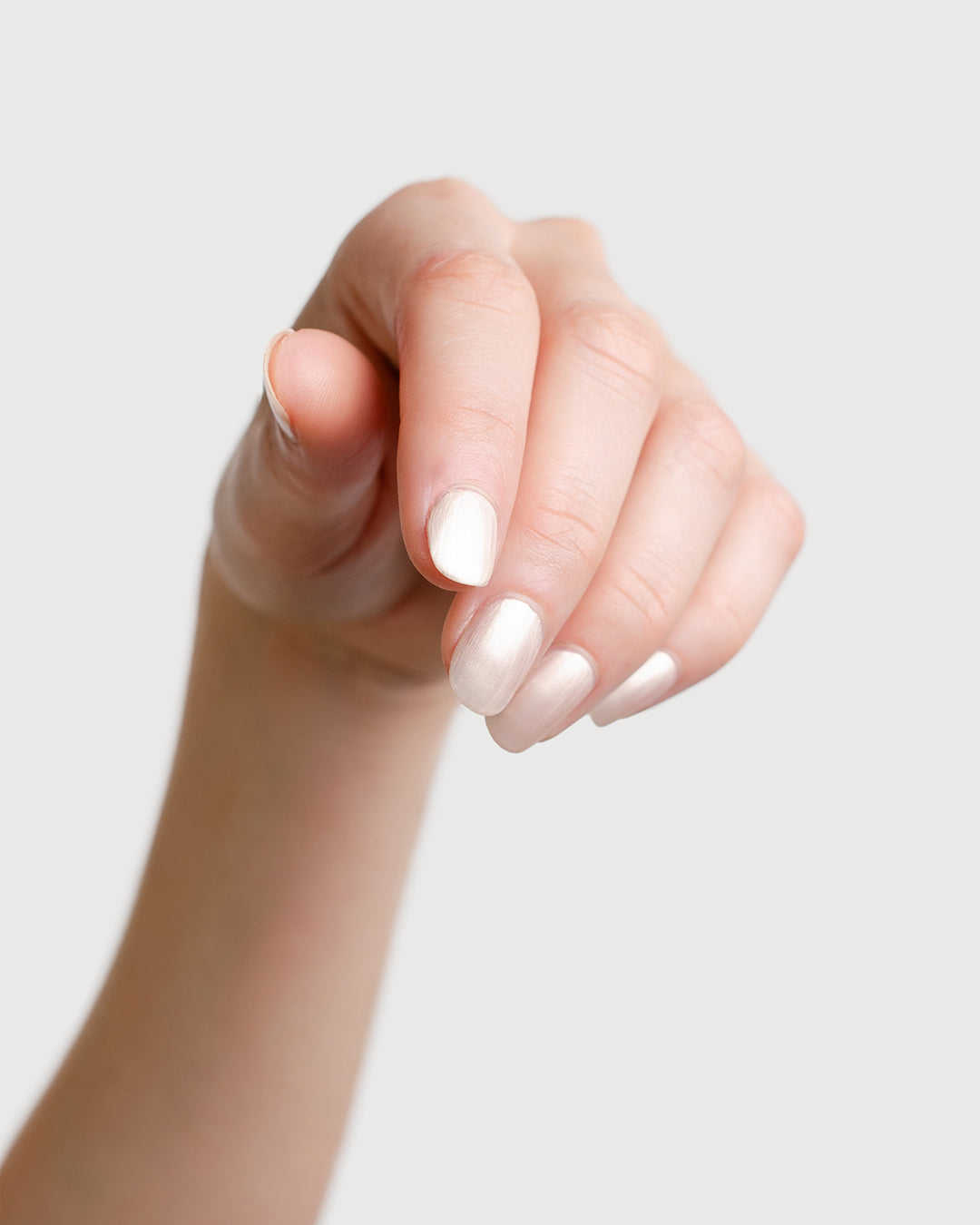 Warm Ivory Pearl Nail Polish Painted on Fair Skin Tone