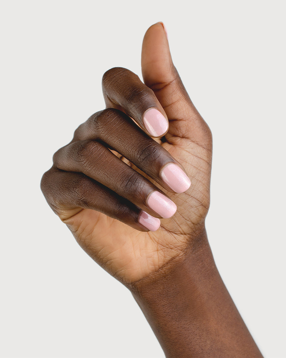 Shimmering Cherry Blossom Nail Polish on Dark Skin Tone