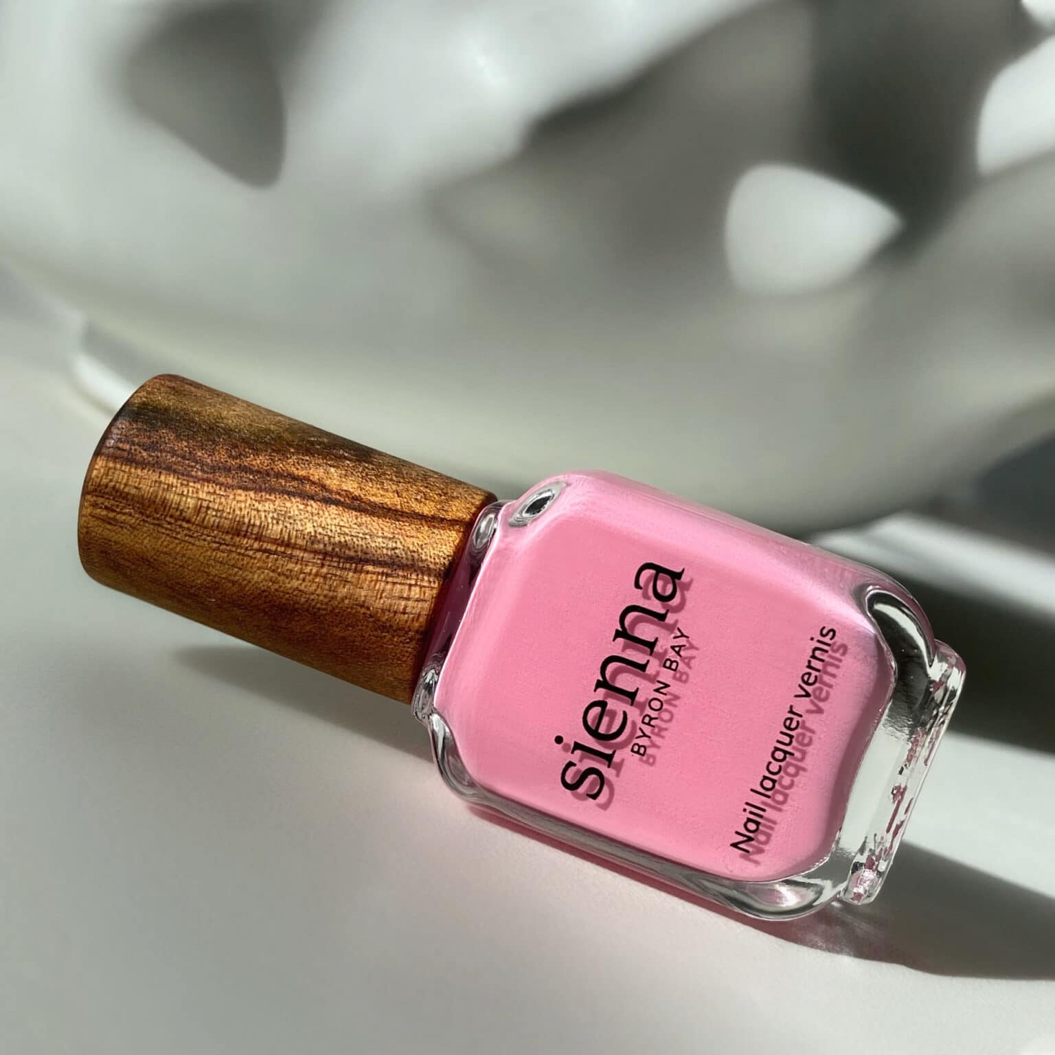 classic pink nail polish bottle with timber cap by sienna