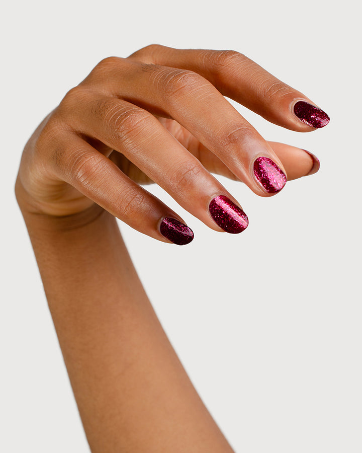 Medium skin tone hand with Starlit Rose metallic shimmer glaze nail colour on beautiful natural nails
