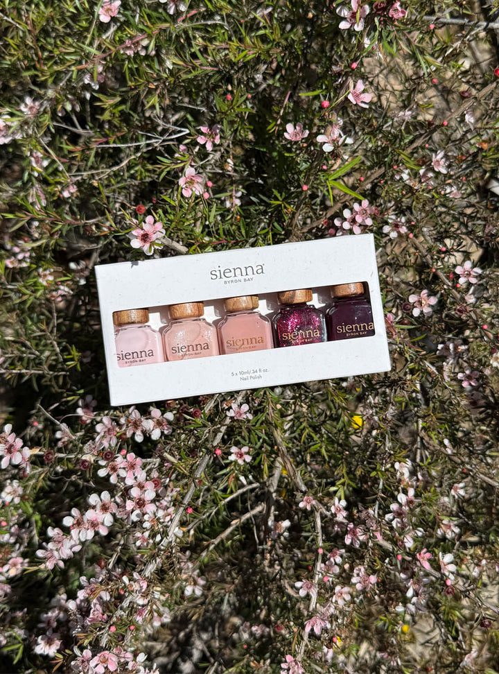 The Midsummer Collection in the Sienna recycled cardboard box amongst a field of Geraldton Wax flower. 
