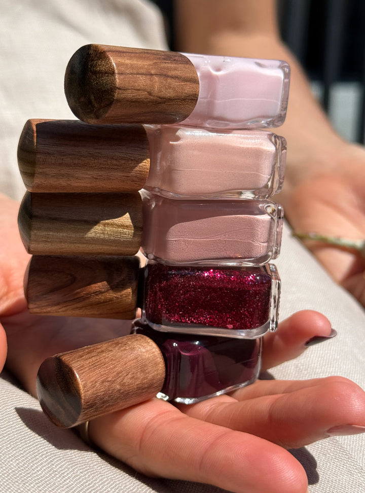 The Midsummer Collection of nail lacquer vernis bottles with signature timber cap. Featuring soft pinks and deep reds