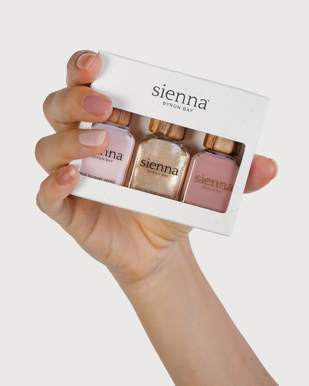 Fair Skin Tone Hand holding the Essence Trio Pack