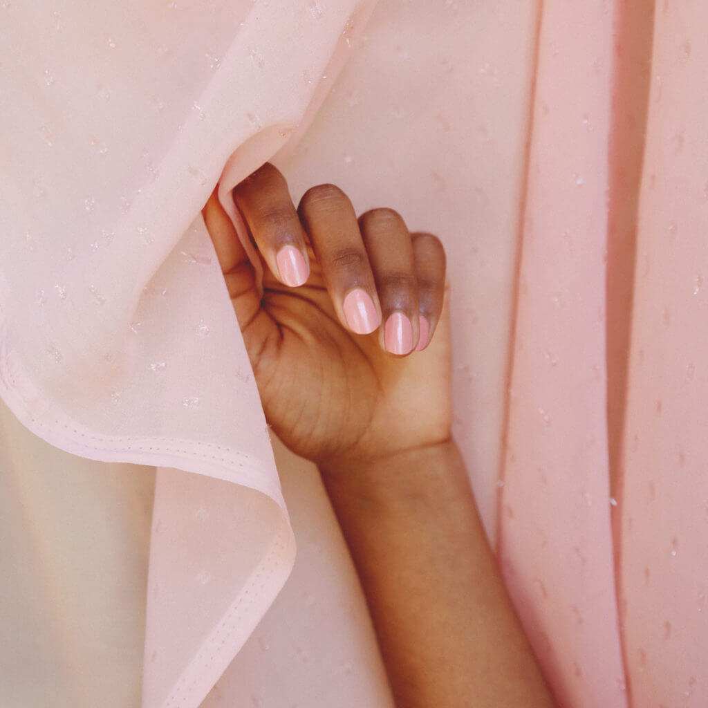 light pink champagne nail polish hand swatch on fair and dark skin tone by sienna