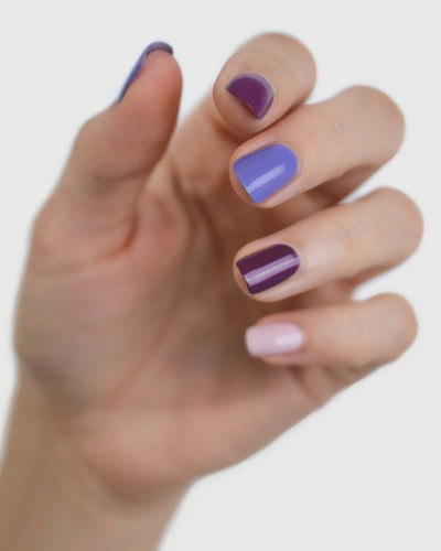 Fair skin hand tone wearing The Quiet Trio Gentle Blue Lilac Crème, Tranquility Light Mauve Rose Crème and Reverence Purple Grape Creme Nail polish..
