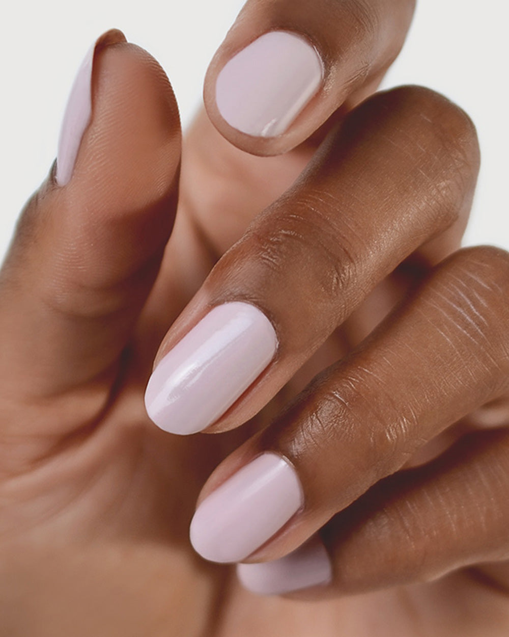 Tranquility Light Mauve Rose Crème nail polish by Sienna Byron Bay on medium skin tone hand.