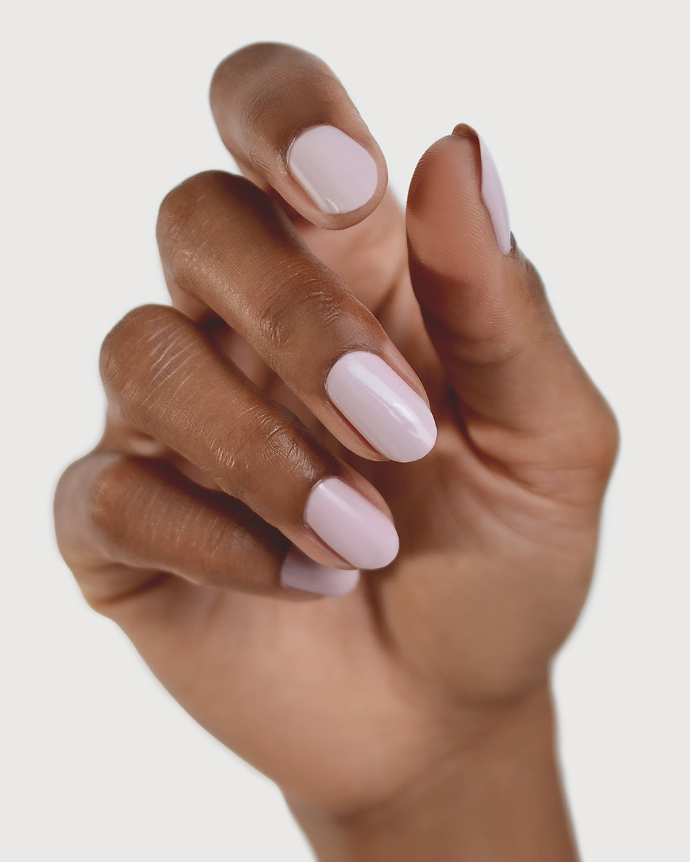 Tranquility Light Mauve Rose Crème nail polish by Sienna Byron Bay on medium skin tone hand.