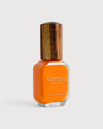 Bright papaya orange nail polish bottle with timber cap by Sienna Byron Bay