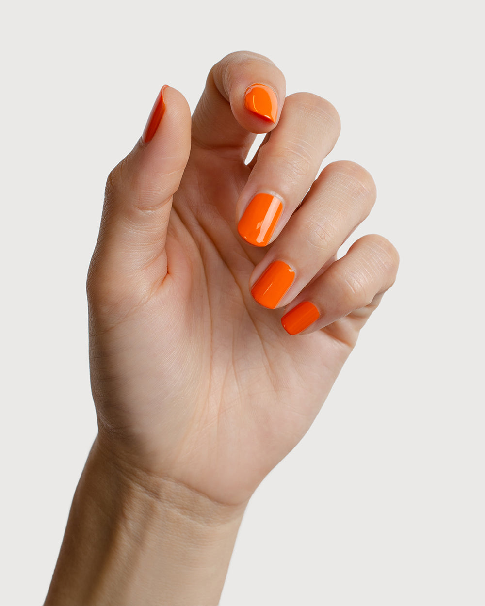 Bright papaya orange nail polish swatch on fair Skin tone by Sienna Byron Bay