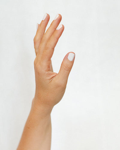 fair skin hand with winter nail polish