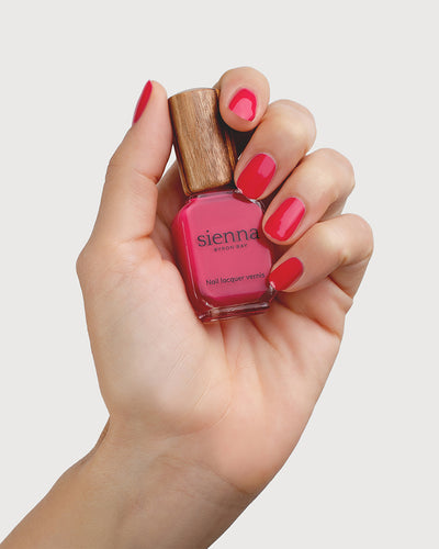 Blooming Fuchsia Petal Pink Nail Polish on Fair Skin Tone with Bottle