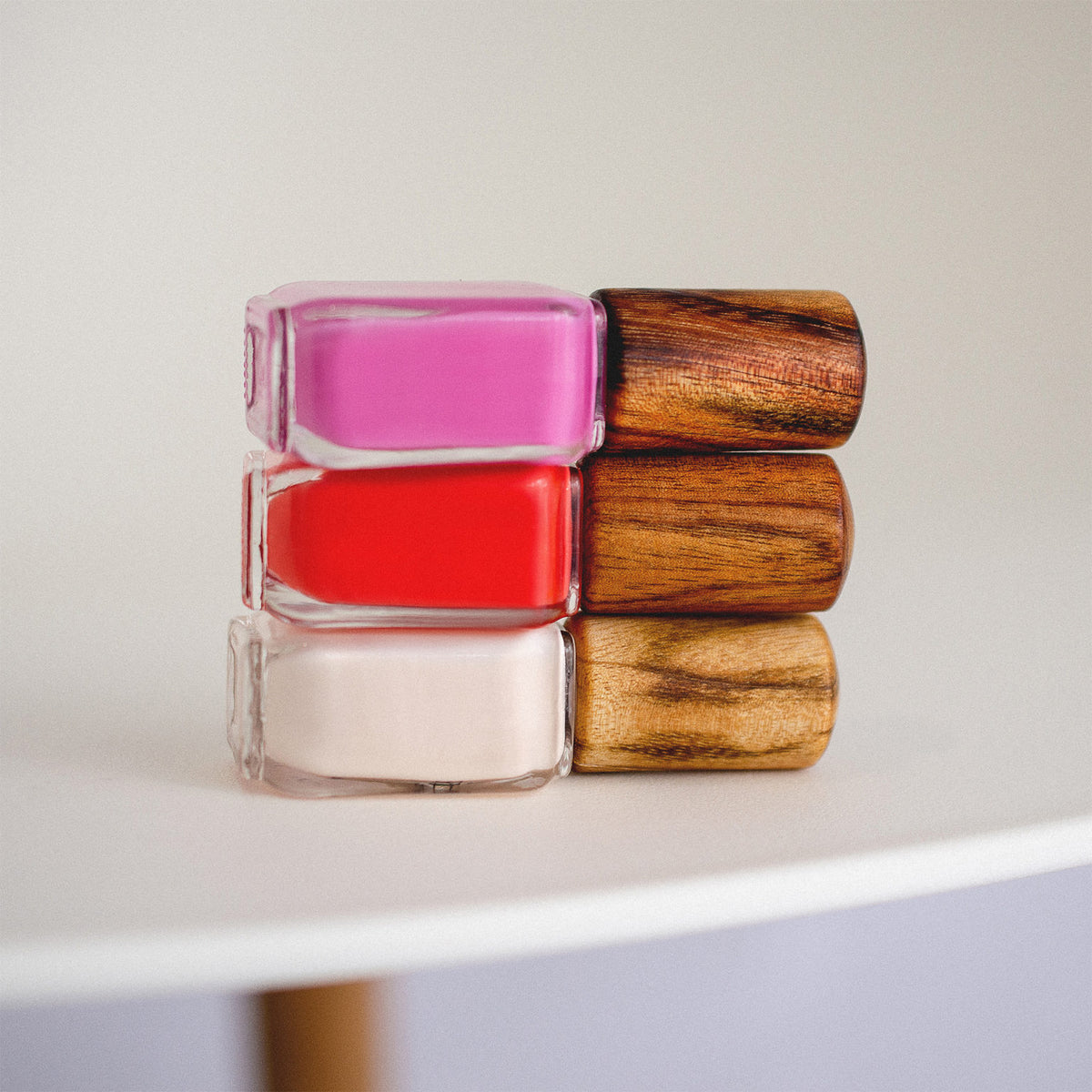 stack of 3 nail polish bottle with timber cap by sienna