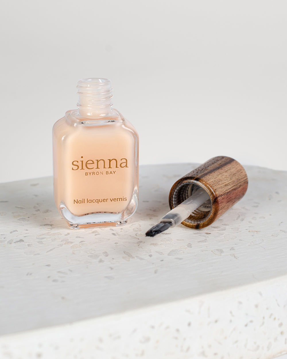 Luscious flourish nail serum, a nourishing nail elixir for nail cuticles and nail plate. With consistent use you will experience stronger, healthier nails. Our flourish nail serum bottle is pictured open, showing the new wide brush for easy application and timber cap.