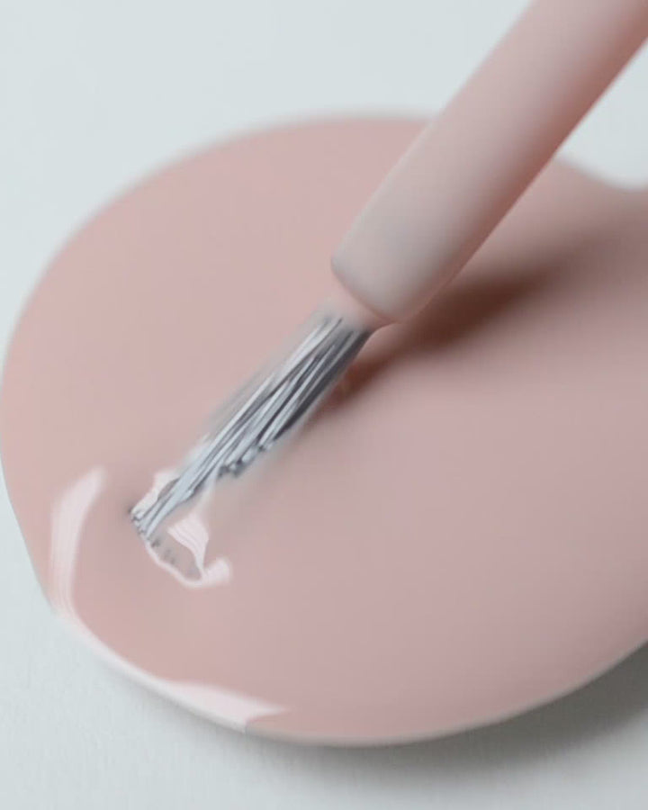 Soft neutral-pink nail polish drop by sienna
