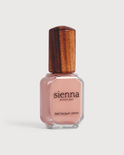 light pink nail polish glass bottle with timber cap