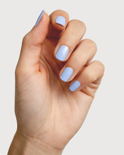Baby blue nail polish hand swatch on fair skin tone