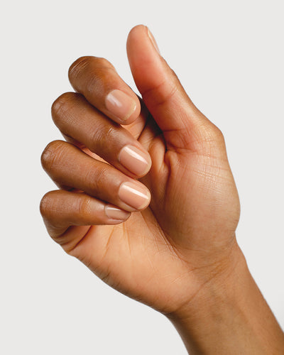 nude sheer nail polish hand swatch on medium skin tone