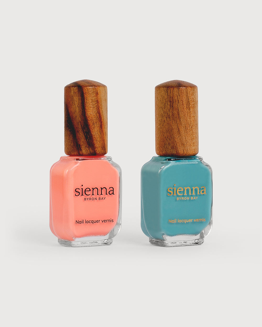 Vibrant peach and Turquoise aqua nail polish glass bottles with timber cap