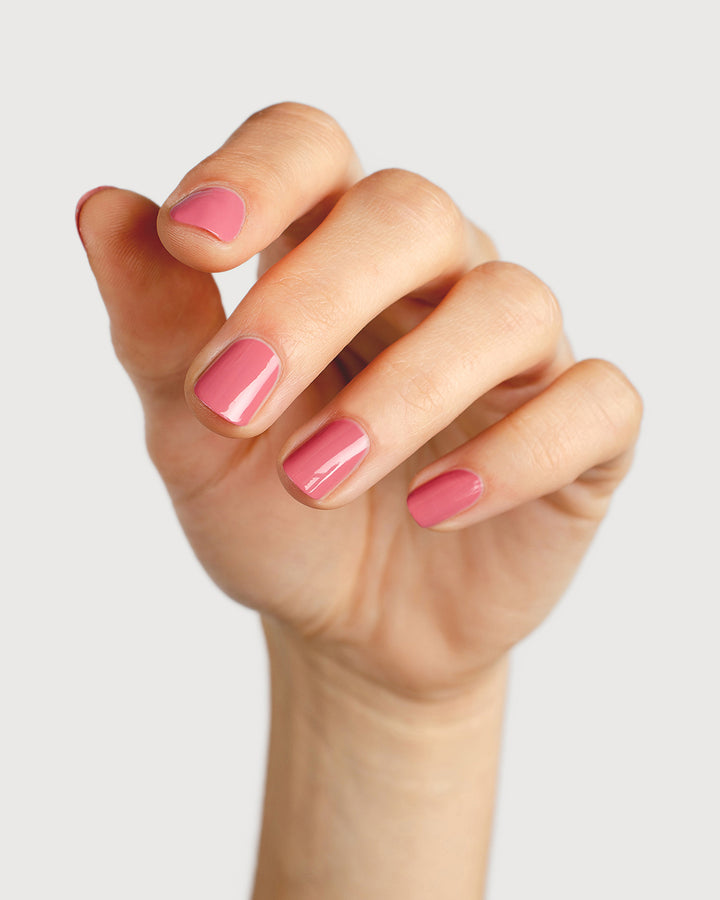 midtone pink nail polish hand swatch on fair skin tone