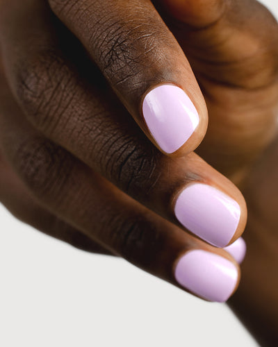 lilac purple nail polish hand swatch on dark skin tone up close