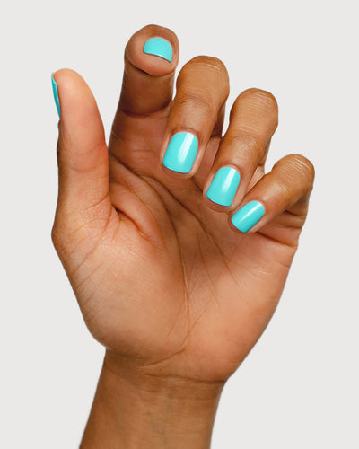 Turquoise aqua nail polish hand swatch on medium skin tone
