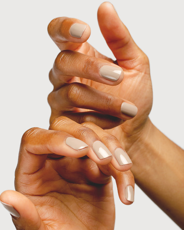 beige nail polish hand swatch on medium skin tone