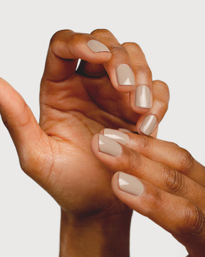 beige nail polish hand swatch on medium skin tone