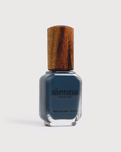 blue-grey nail polish glass bottle with a timber cap