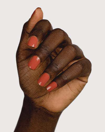 terracotta nail polish hand swatch on dark skin tone