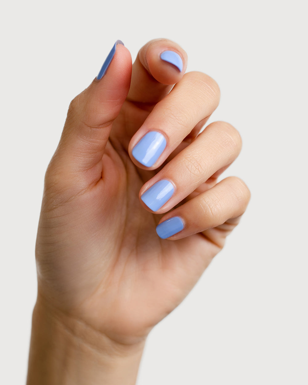 periwinkle blue nail polish hand swatch on fair skin tone