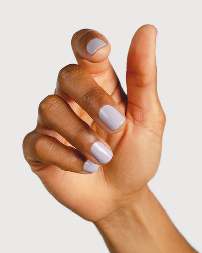 Thistle purple-grey nail polish hand swatch on medium skin tone